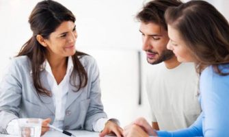 Representing A Bank Manager and Young Couple Discussing About Loan Documents.