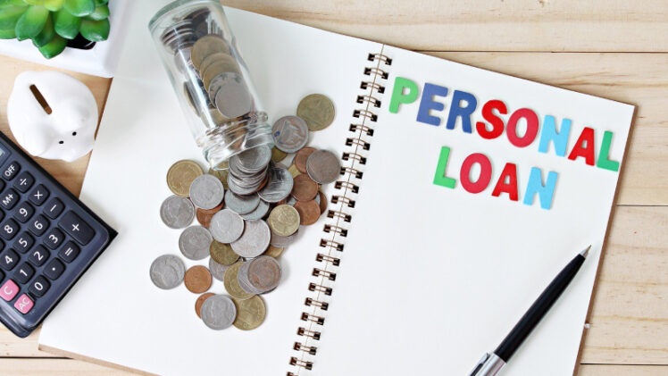 Bottle of Coins Placed On The Notebook That Representing Personel Loan Concept.