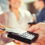 Close up Image of A Hand Using Credit Card Swiping Machine.