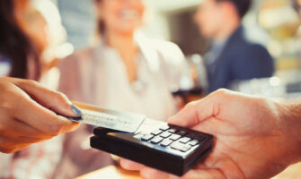 Close up Image of A Hand Using Credit Card Swiping Machine.