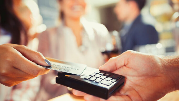 Close up Image of A Hand Using Credit Card Swiping Machine.