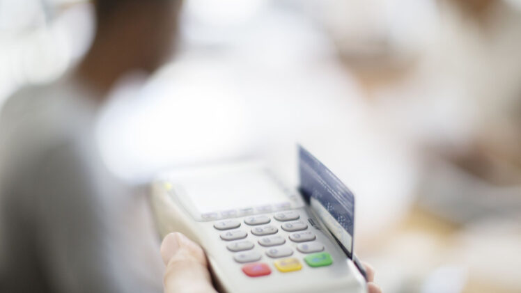 A Blurred Image of Credit Card Swiping Machine.
