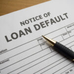 An Image Of A Notice of Loan Default Placed On The Table.